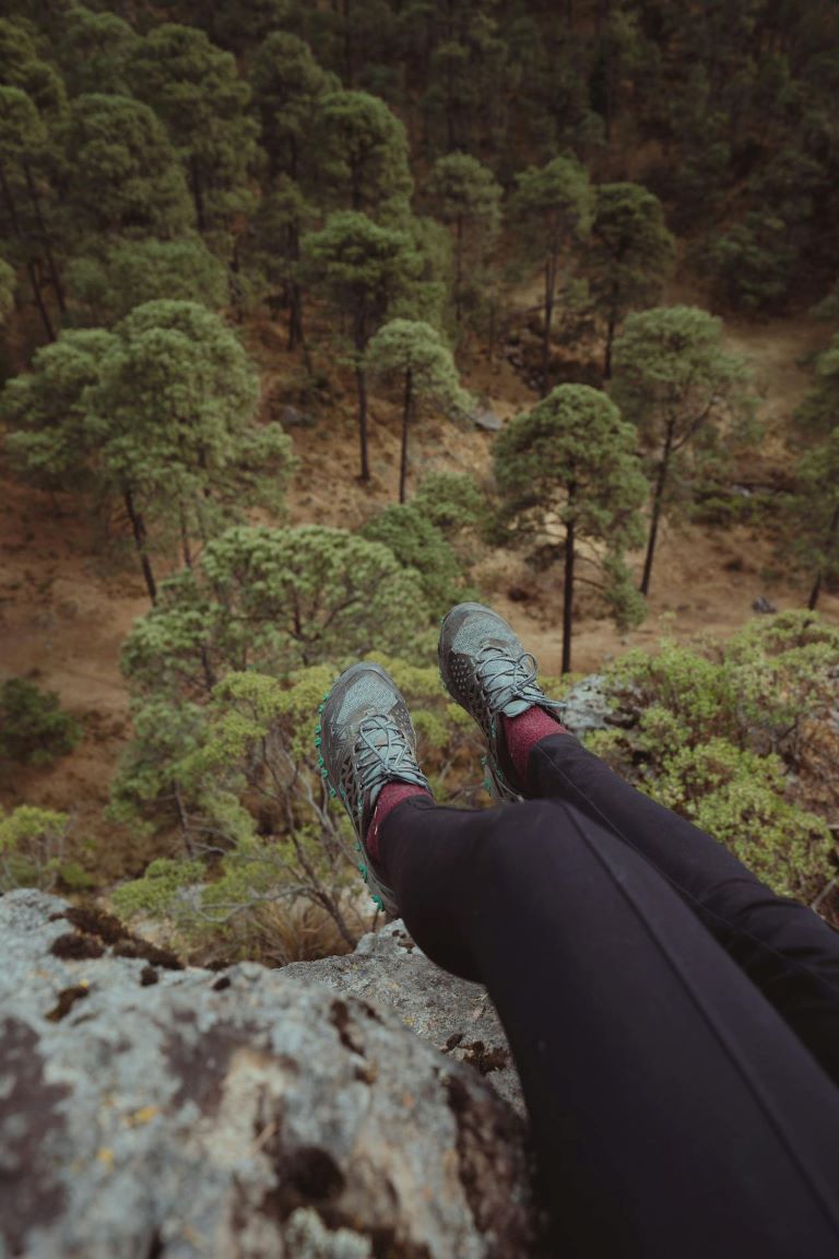 Woman Feet Hanging Over Cliff